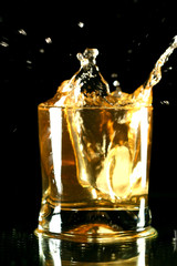whiskey splash on black background