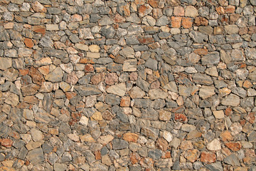 Stones and rocks in a wall. May be used as a background