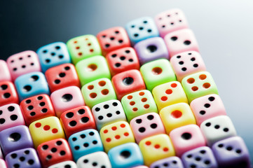 Plastic colorful dices over glass surface