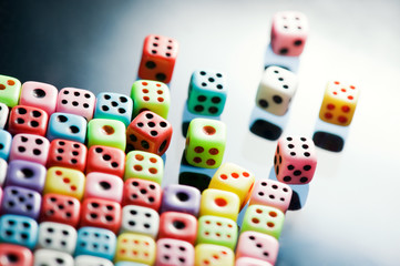 Plastic colorful dices over glass surface