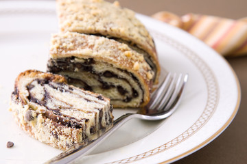 Slice of rich chocolate cake layered in crispy breads.