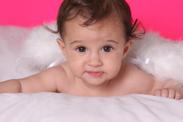 cute baby girl withangel wings on pink background