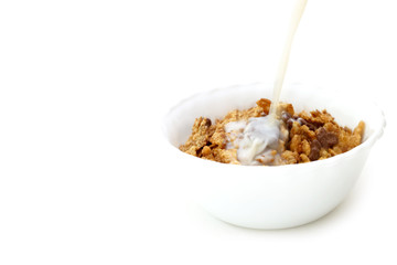 Milk and cereals in a white bowl