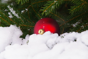 a red bauble in snowy landscape
