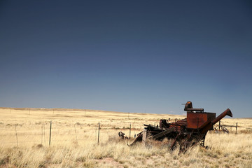 Fototapeta premium vintage combine harvester and old field of rye, Arizona, USA