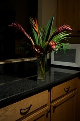 Modern kitchen with granite counters and flowers