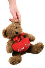 Teddy bear and big red heart, isolated on white background