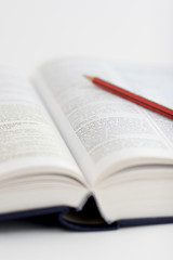 open book and pen with very shallow depth of field