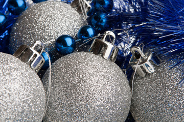 Silver shiny Christmas balls with tinsel and beads, closeup