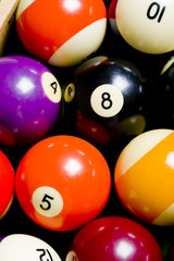 A colorful pool or billiard ball background with the 8-ball