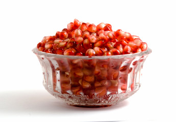 Goblet full of pomegranate arils isolated on white background