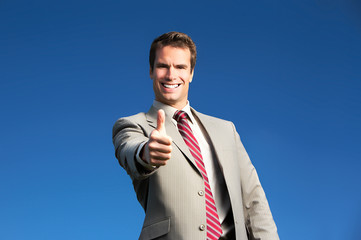 Happy successful  businessman  under blue sky. Portrait.