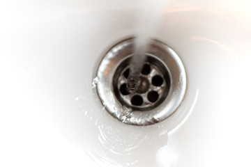 Sink Hole Under Running Water Tap