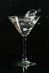 martini splash on black background close up