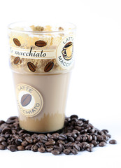 Latte Macchiato in glass costing on coffee grain