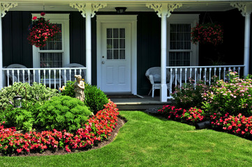Landscaped front yard of a house with flowers and green lawn - 10204489