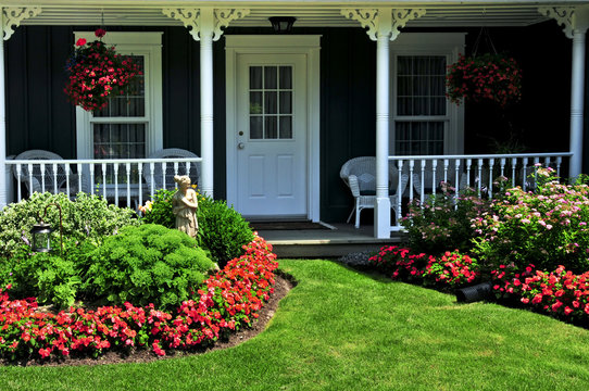 Landscaped front yard of a house with flowers and green lawn