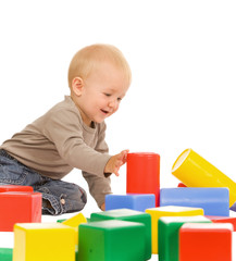 Fototapeta premium little boy play with bricks. isolated on a white background