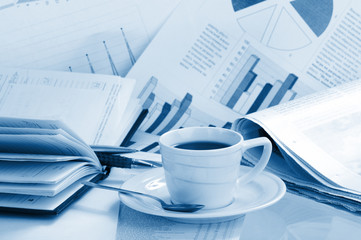 Cup  coffee on a morning paper business news