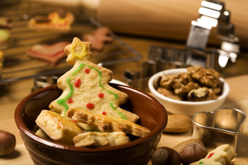 cookies in bowl, christmas tree shape in focus, baking utensil