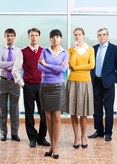 Photo of confident managers standing in office