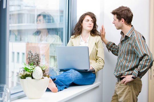 Male and female office workers talking and brainstorming