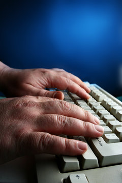 Hands close-up typing on the keyboard