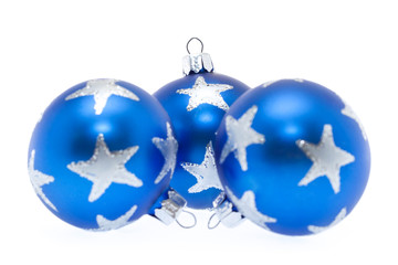 Three blue christmas balls over white