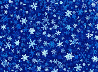 A snowflake illustration on a textured blue background.