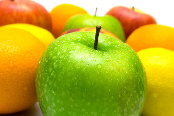 Allsorts from several fruits covered by water drops on a white