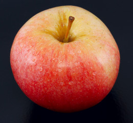 Red-yellow apple on black background