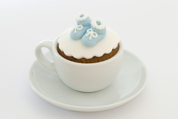 Christening cupcake with blue booties for a boy