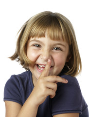 Fototapeta premium Blonde 7 year-old girl laughing with pointing finger