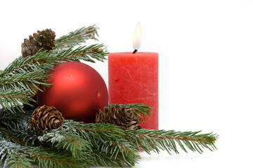 Christmas composition of conifer, red baubles and candle