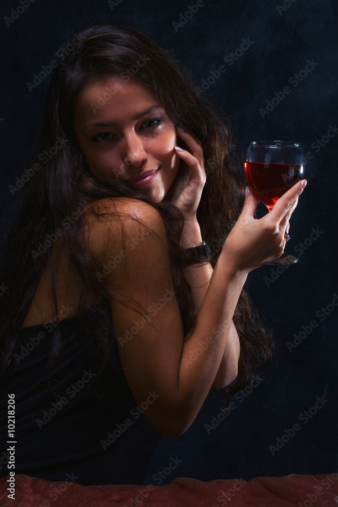 Wall mural woman in dark with wine glass,