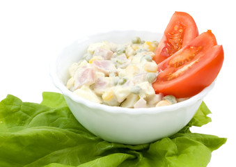 American salad and sliced tomatoes in a bowl isolated on white.