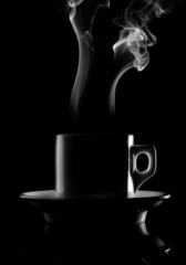 Cup of hot drink with steam isolated over black background