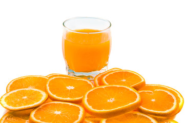many orange slices and juice isolated on white. Focus on slices