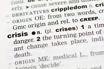 A close up of the word crisis from a dictionary