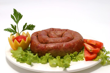 home made sausage served with salad and tomatoes