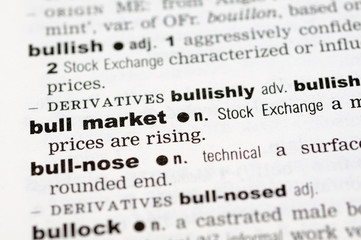 A close up of the word bull market from a dictionary