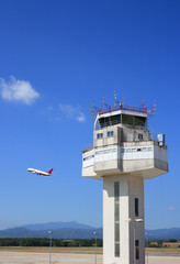 Airport control tower and airplane taking-off