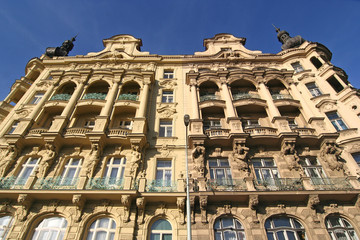 Classic mansions with statues and balconies in Prague
