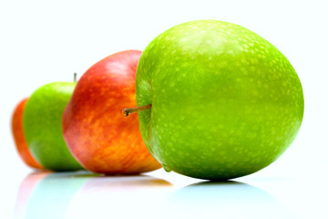 The red and green apples on white. Isolation, shallow DOF.