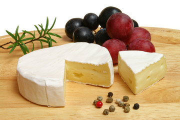 Camembert - soft cheese served on a wooden board