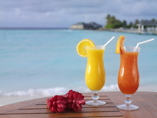 two fresh juice orange and papaya on the table on blue sky