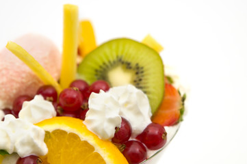 Fresh juicy fruit cocktail with whipped cream closeup