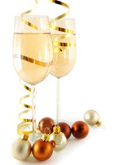 Two glasses with champagne and christmas ball near