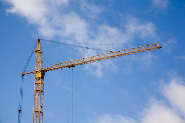 Tower of the building crane against the sky