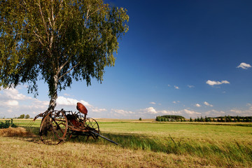 On countryside, old agricultural machine